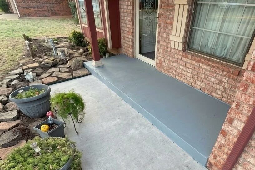 After: front porch freshly painted in a clean blue finish
