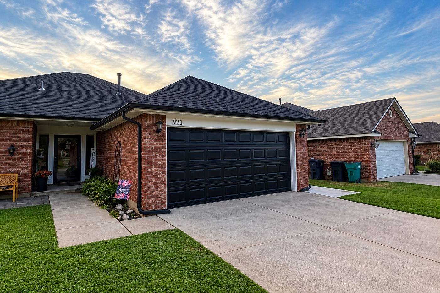 Brick home with a clean driveway, trimmed lawn and tidy exterior